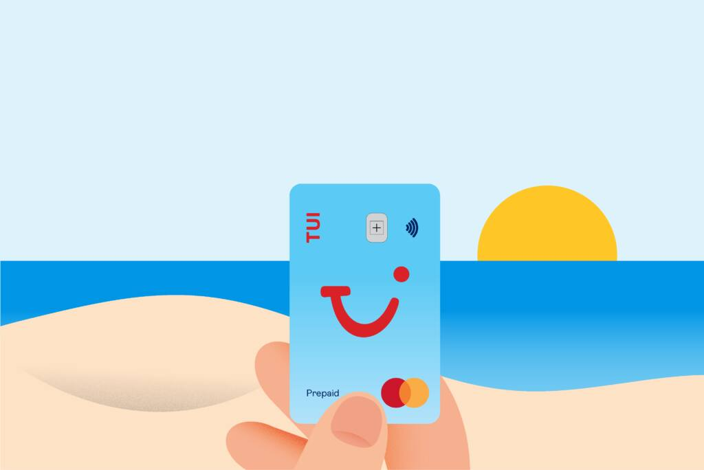 TUI Prepaid Mastercard held against a beach and sunset