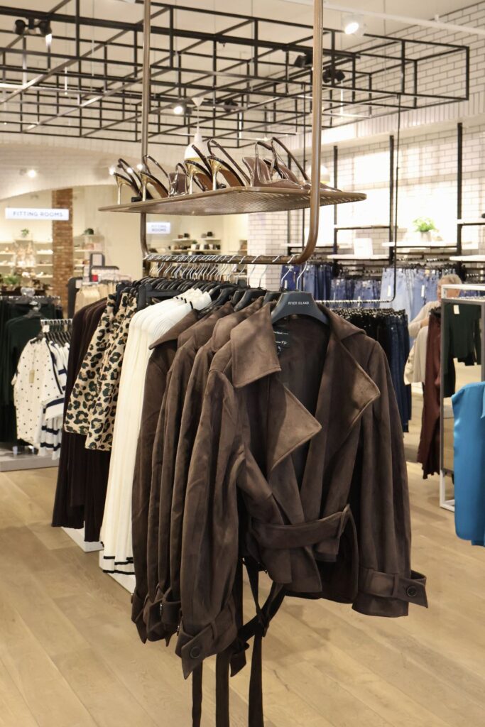 Brown suede trench coats on a rail